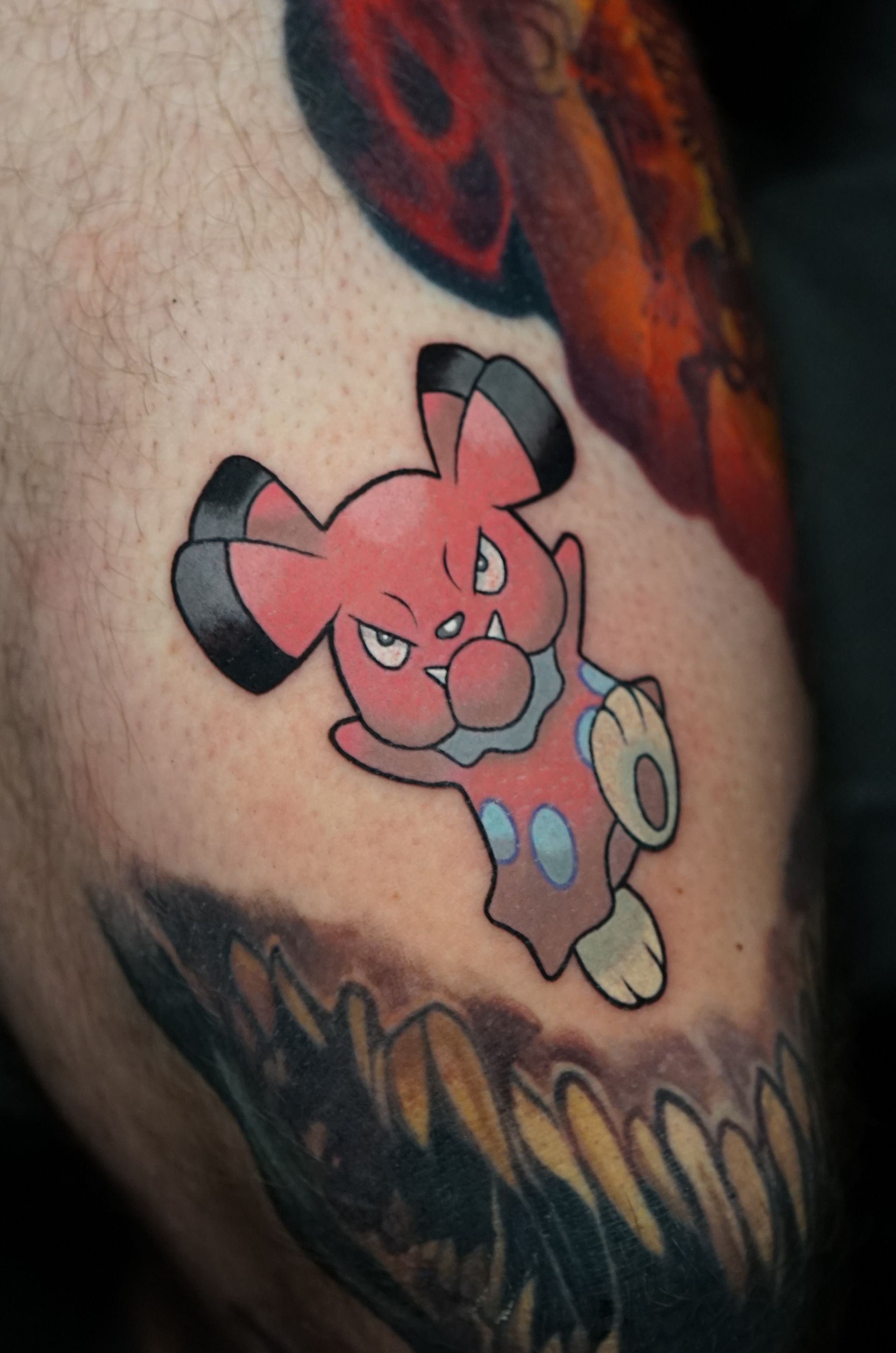 A person has a tattoo of a pig on their arm