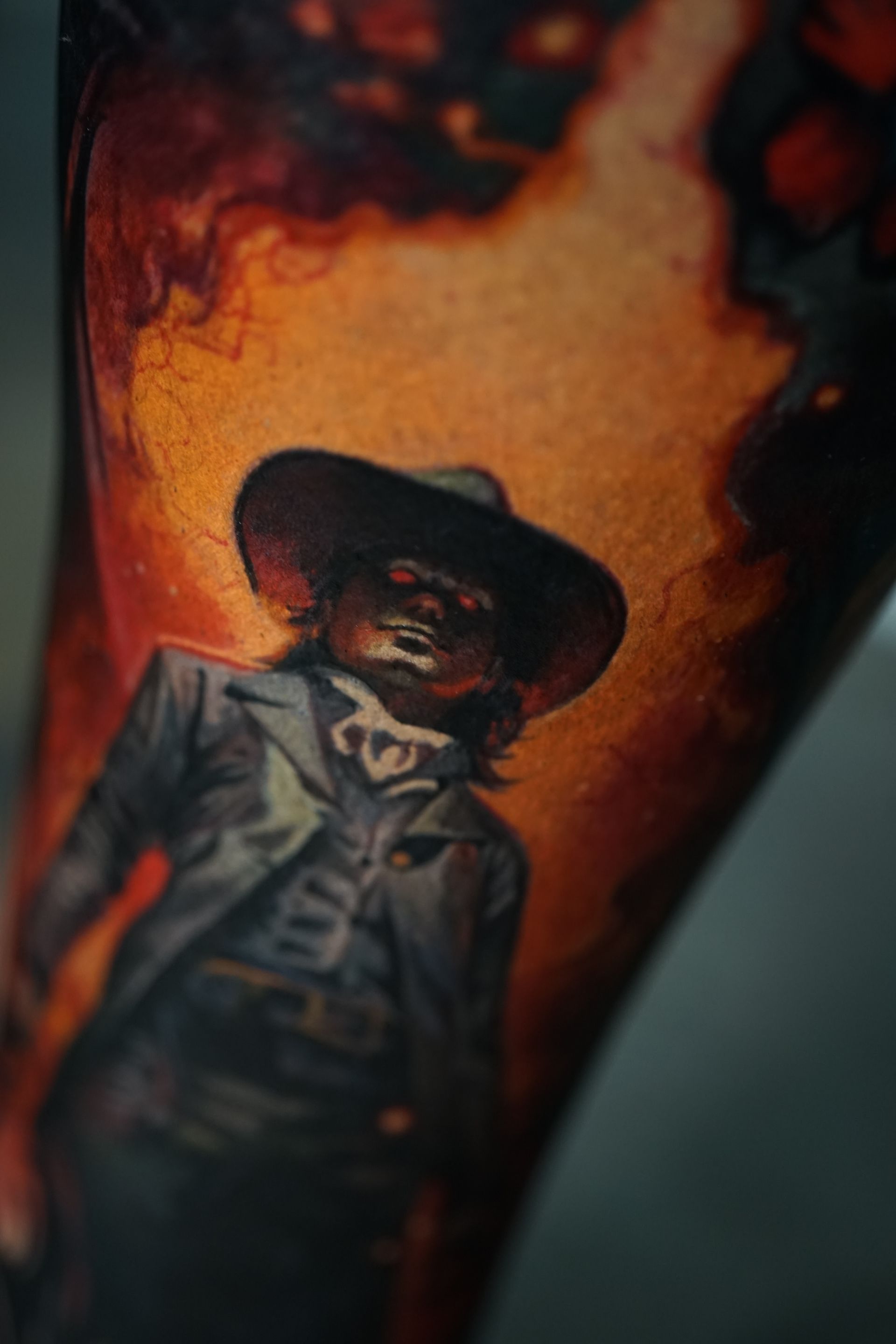 A close up of a tattoo of a cowboy on a person 's arm.