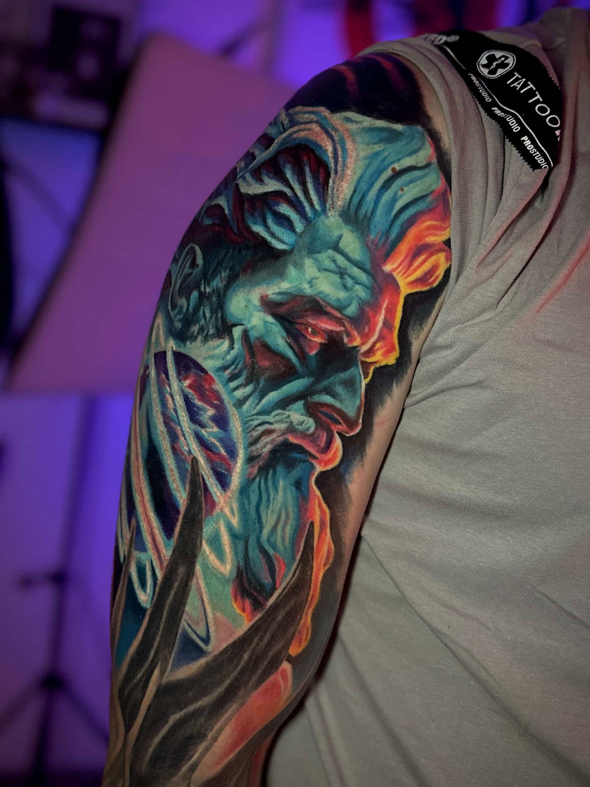 A tattoo of a pikachu and a light bulb on a person 's arm
