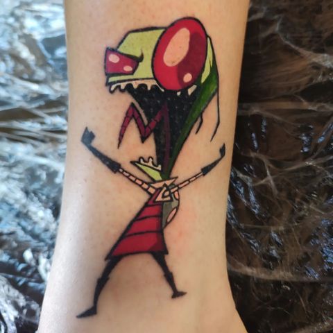 A person has a tattoo of a cartoon character on their leg