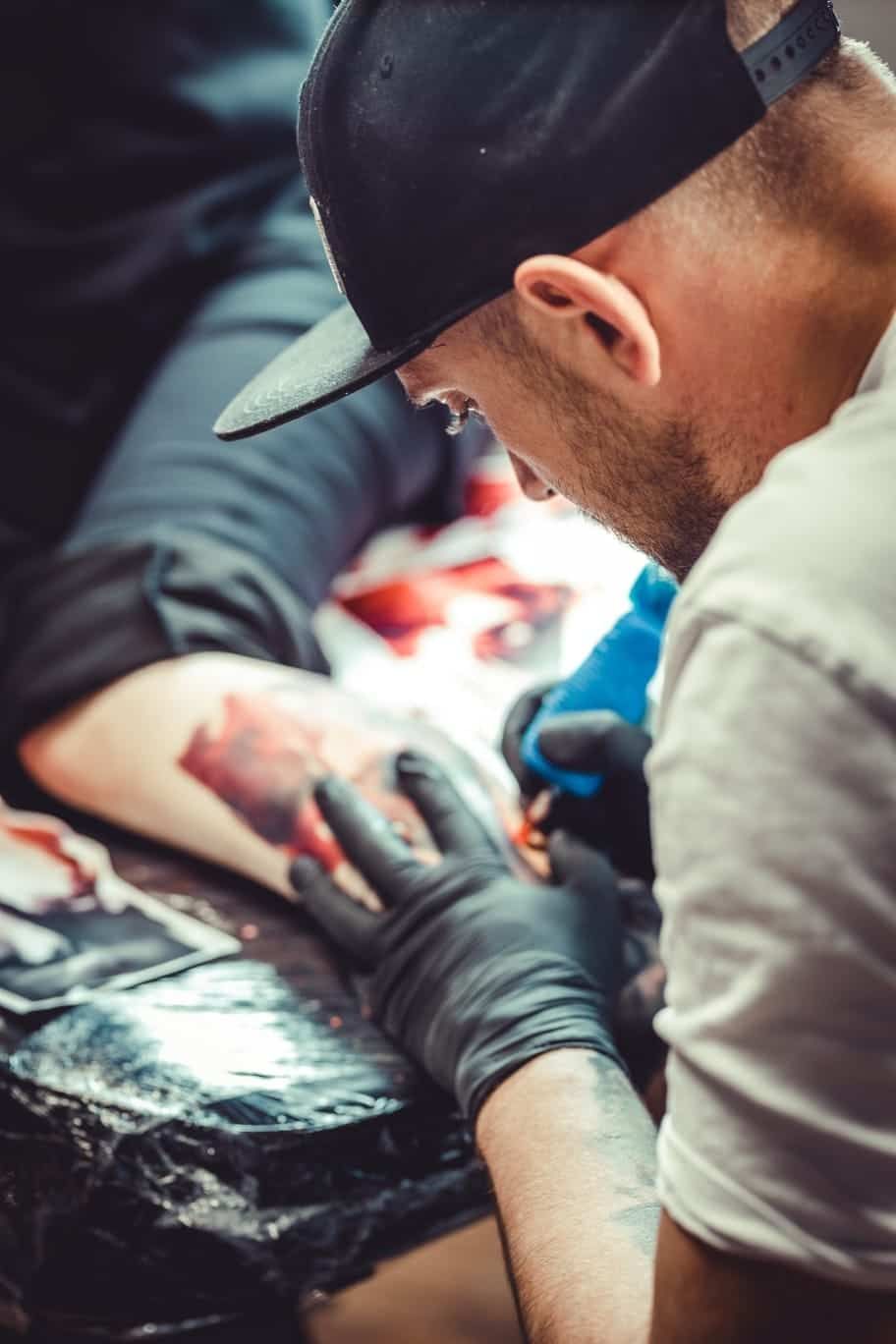 A woman with long hair and a nose ring is smiling.