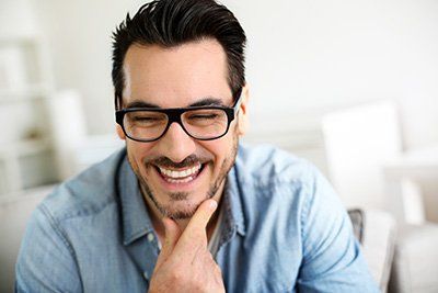 Smiling Man Wearing an Eyeglass - Hartzell Rupp Ophthalmology in Mechanicsburg, PA