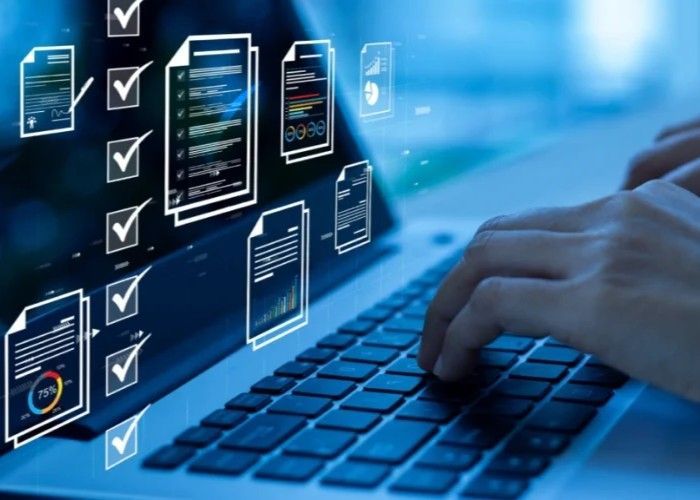 Hands typing on a laptop with blue-toned digital overlays of documents and checklists appearing on the screen.