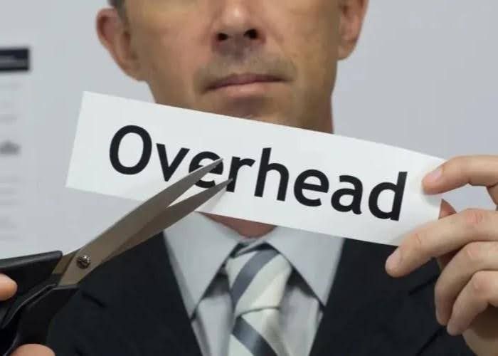 Man in suit using scissors to cut a sign that reads 