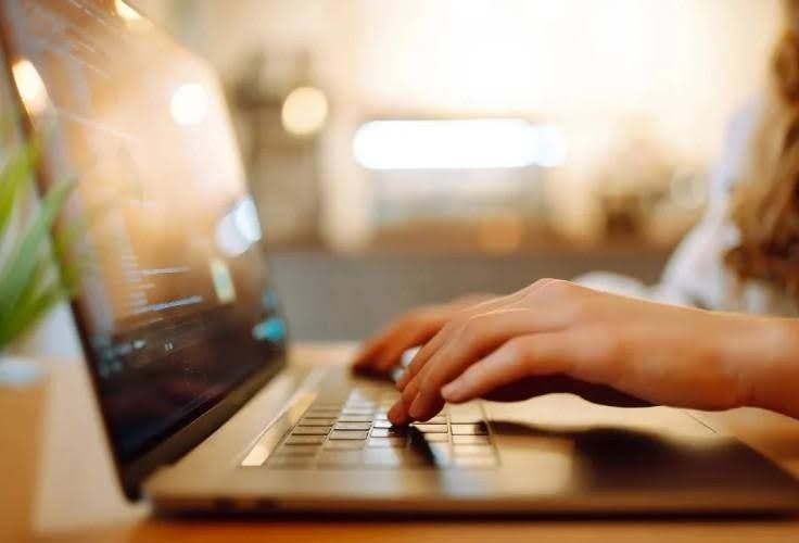 woman typing on a laptop