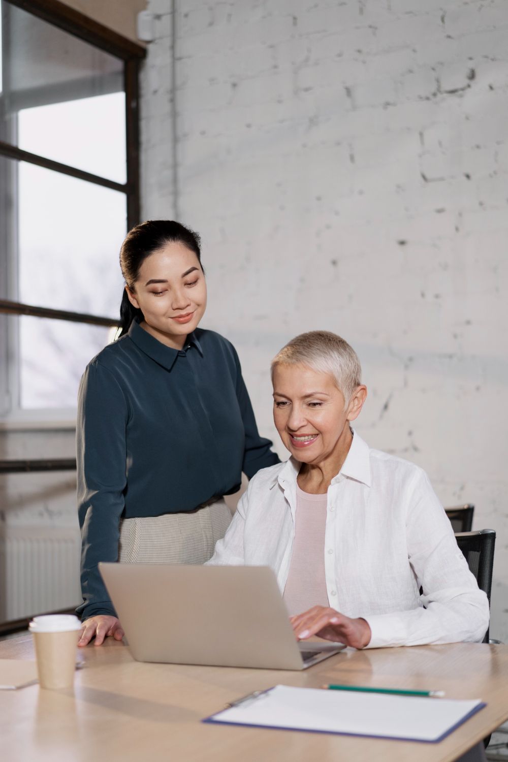 A woman is writing on a clipboard with a pen.