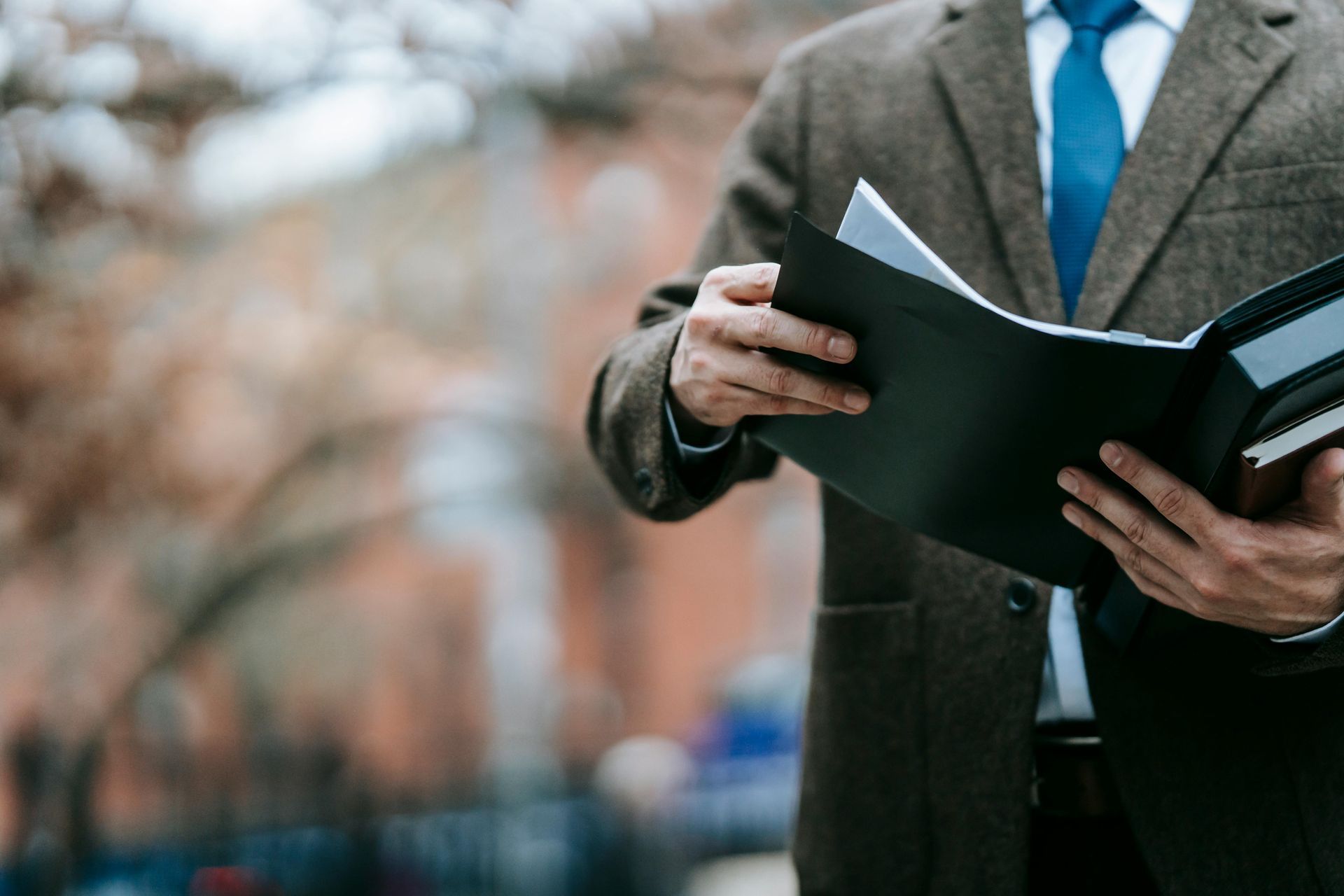 A woman is writing on a clipboard with a pen.