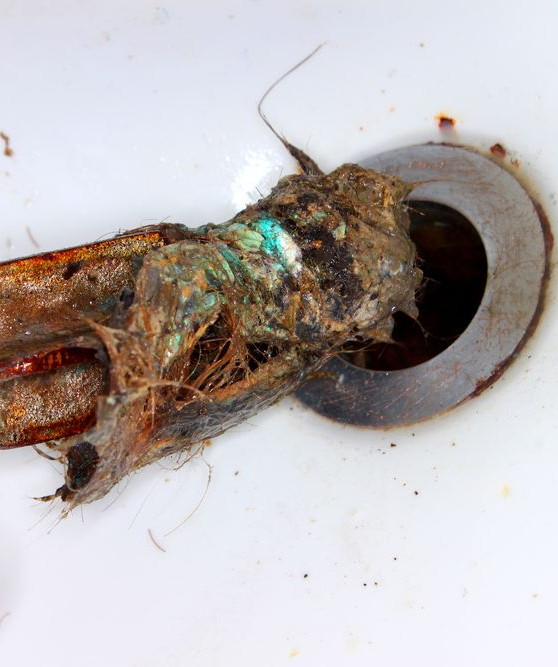 Man is Fixing a Kitchen Sink With a Tool Bag Full of Tools — Off-Tap Plumbing NQ In Currajong, QLD