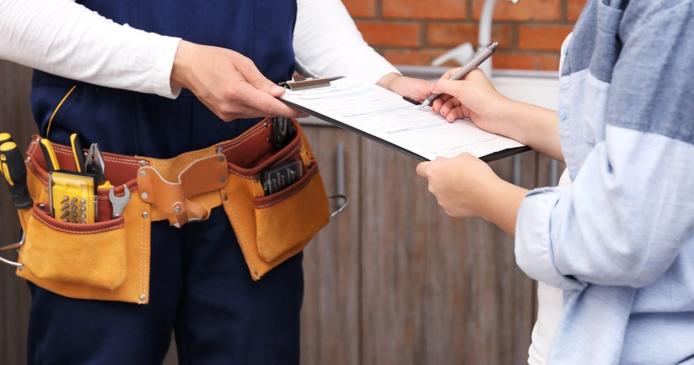 Man is Fixing a Kitchen Sink With a Tool Bag Full of Tools — Off-Tap Plumbing NQ In Currajong, QLD