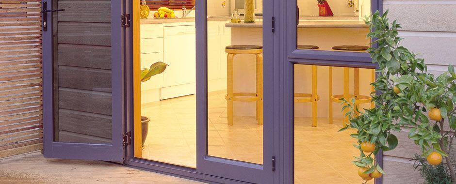 Purple Door With Yellow Trim Open To A Kitchen — Atherton Glass In Atherton, QLD