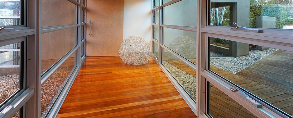 Long Hallway With Wooden Floors And Lots Of Windows — Atherton Glass In Atherton, QLD