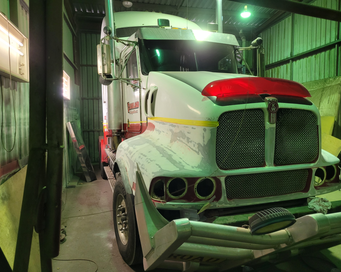 Two small planes are parked on a runway at an airport