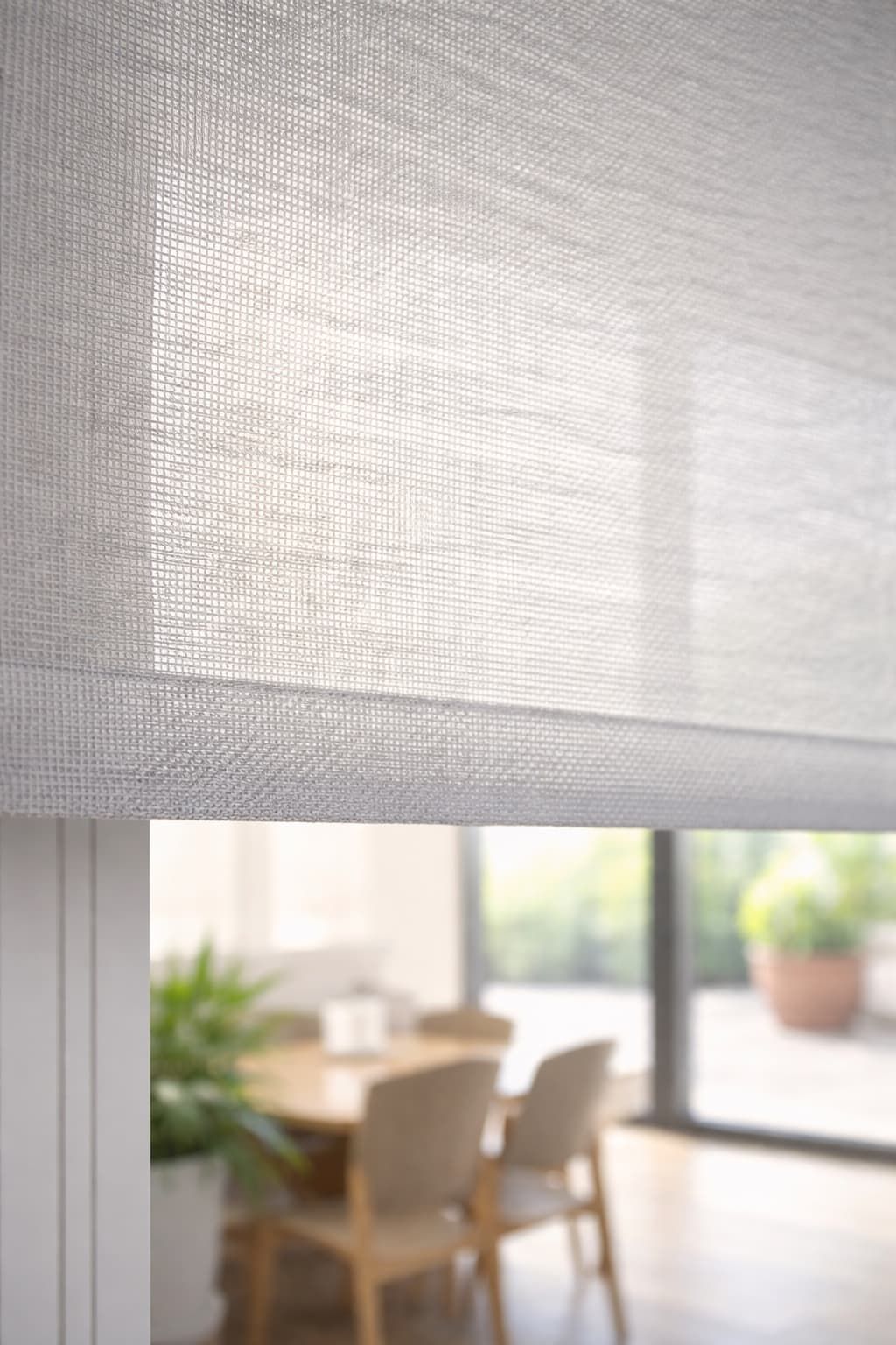 Close-up of roller blind fabric filtering sunlight