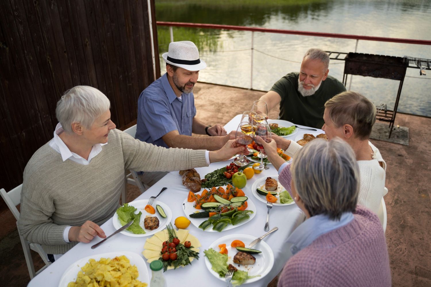 A group of people are sitting around a table eating food.