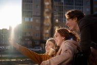 A group of people are taking a selfie in front of a building.