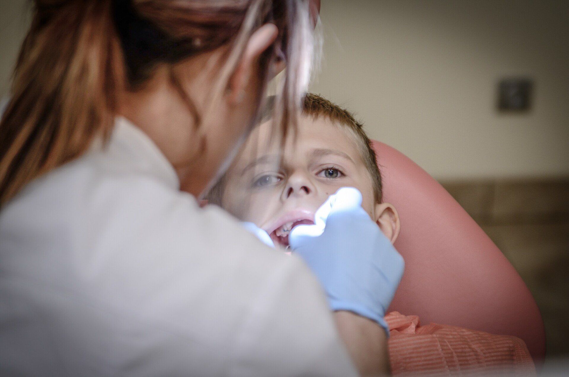 dentist checking a kids mouth
