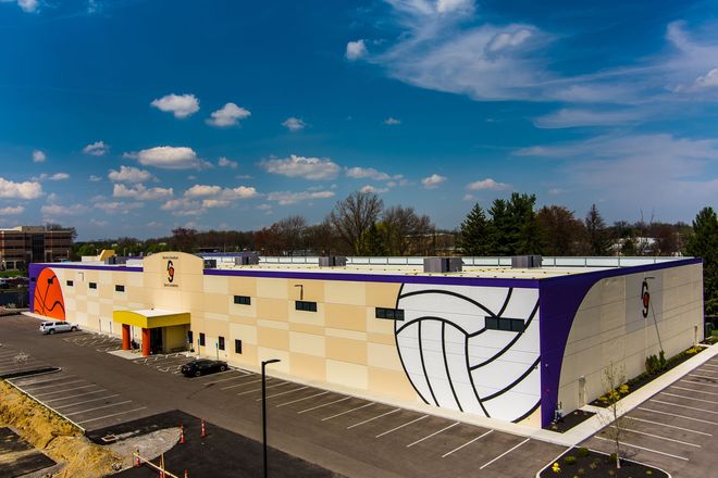 An aerial view of a large building with a basketball on the side.