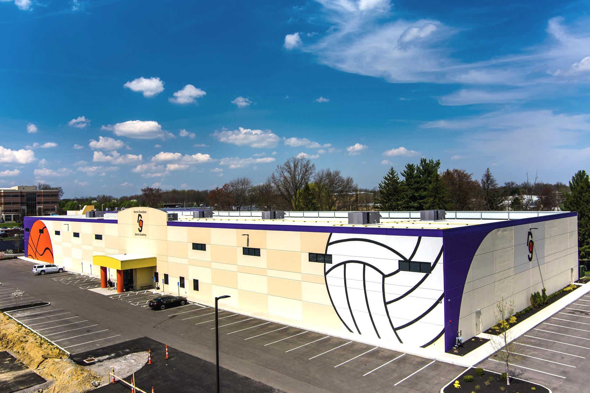 An aerial view of a large building with a basketball on the side.