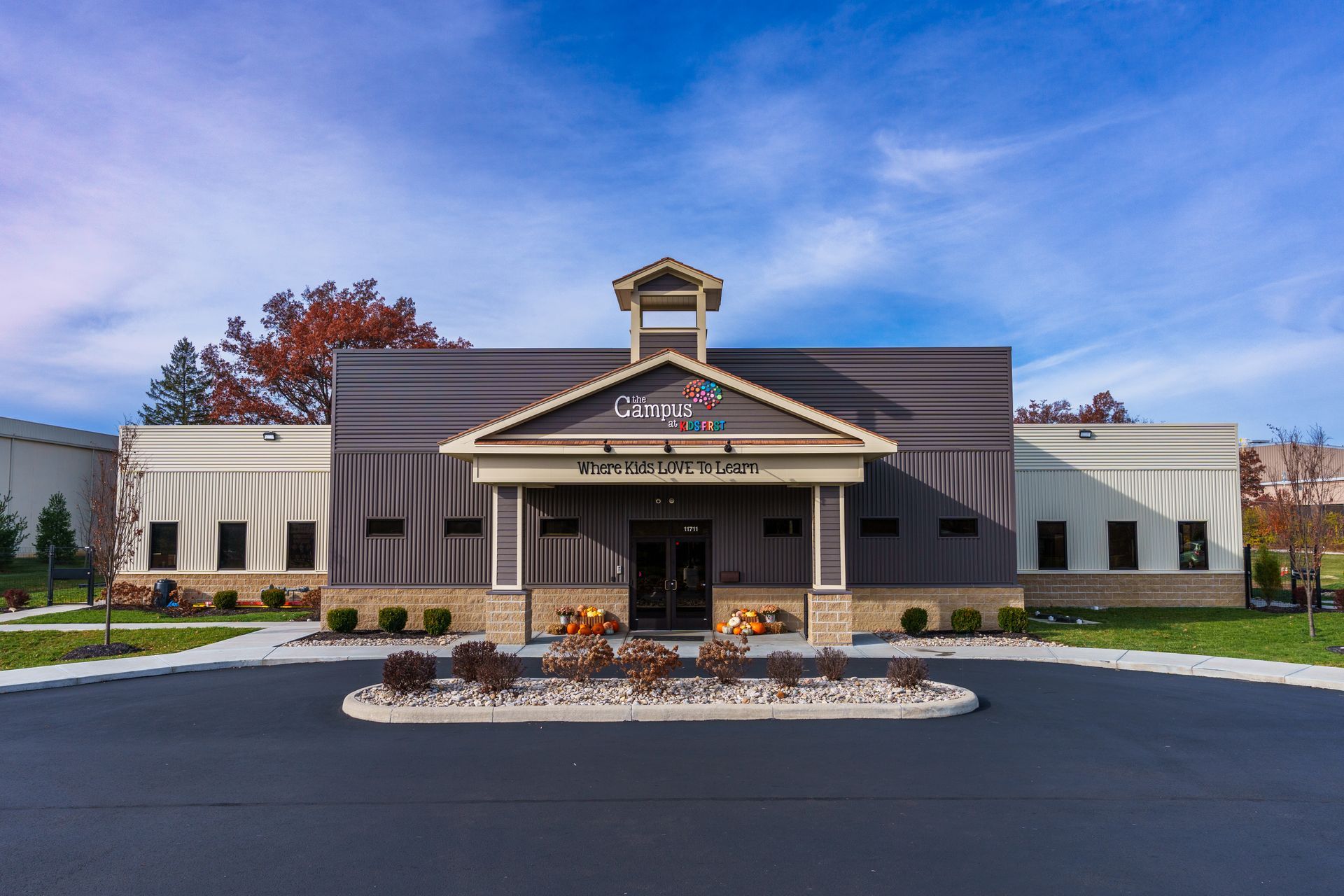 An aerial view of a large building with a parking lot in front of it.