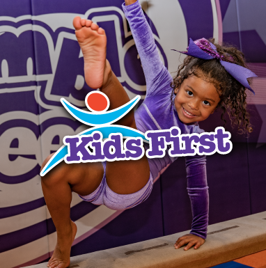 A little girl is doing a handstand on a balance beam for kids first