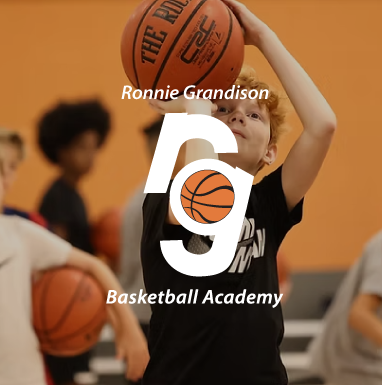 A boy holding a basketball with the name ronnie grandison on it