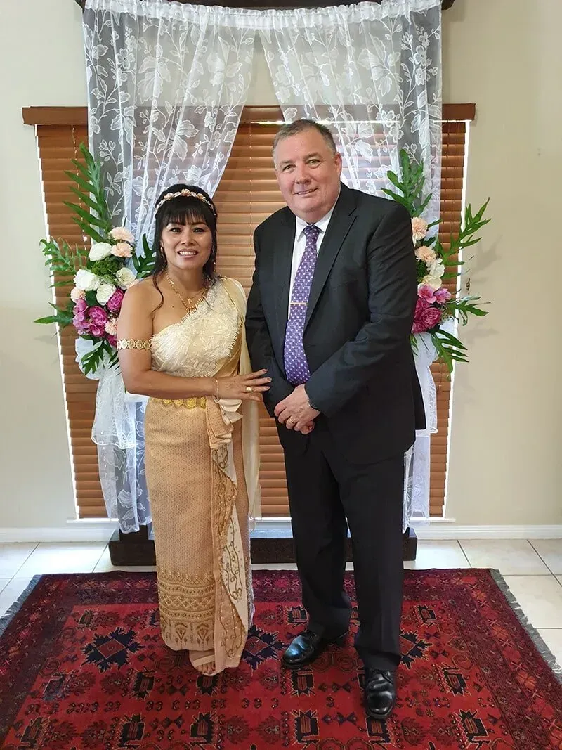A Man in a Suit is Standing Next to a Woman in a Wedding Dress — GinaS Cairns Tropical Weddings in Parramatta Park, QLD