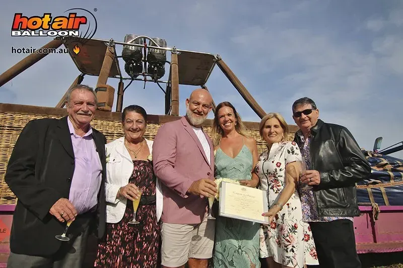 A Group of People Standing in Front of a Hot Air Balloon — GinaS Cairns Tropical Weddings in Parramatta Park, QLD