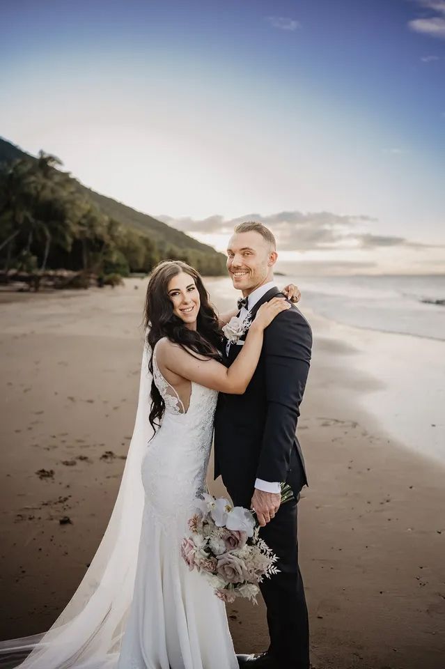 A Bride and Groom Are Posing for a Picture on the Beach — GinaS Cairns Tropical Weddings in Palm Cove, QLD