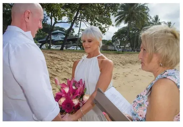 A Man and Woman Are Holding Hands During a Wedding Ceremony — GinaS Cairns Tropical Weddings in Parramatta Park, QLD