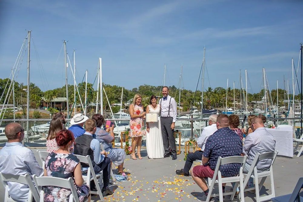A Bride and Groom Are in Front of a Crowd of People at a Wedding — GinaS Cairns Tropical Weddings in Parramatta Park, QLD