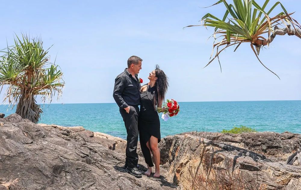 A Man and a Woman Are Standing on a Rock Near the Ocean — GinaS Cairns Tropical Weddings in Parramatta Park, QLD