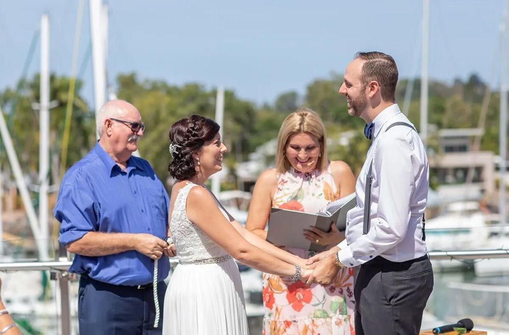 A Bride and Groom Are Holding Hands During Their Wedding Ceremony — GinaS Cairns Tropical Weddings in Parramatta Park, QLD