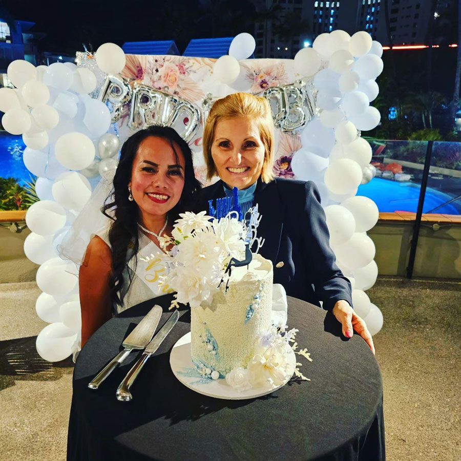 Two Women Are at a Table With a Cake and Balloons in the Background — GinaS Cairns Tropical Weddings in Parramatta Park, QLD