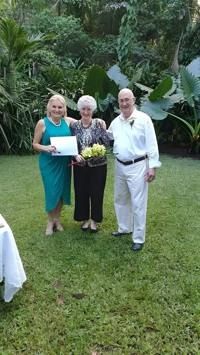 A Group of People Standing Next to Each Other on a Lush Green Field — GinaS Cairns Tropical Weddings in Parramatta Park, QLD