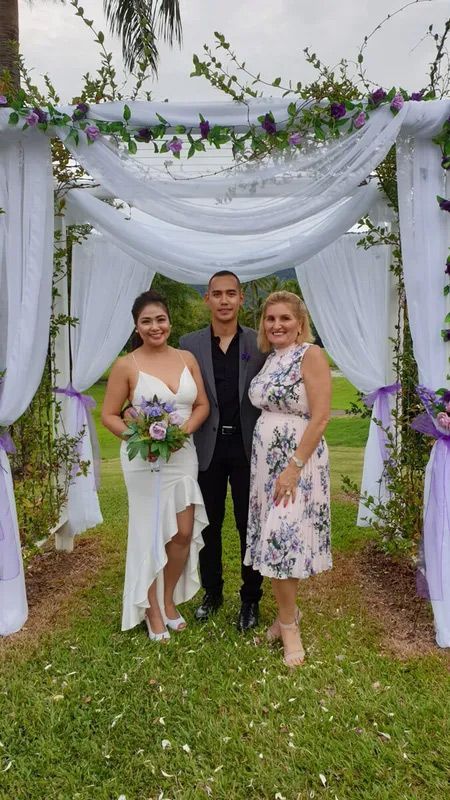 A Bride and Groom Are Posing for a Picture Under a White Canopy — GinaS Cairns Tropical Weddings in Parramatta Park, QLD