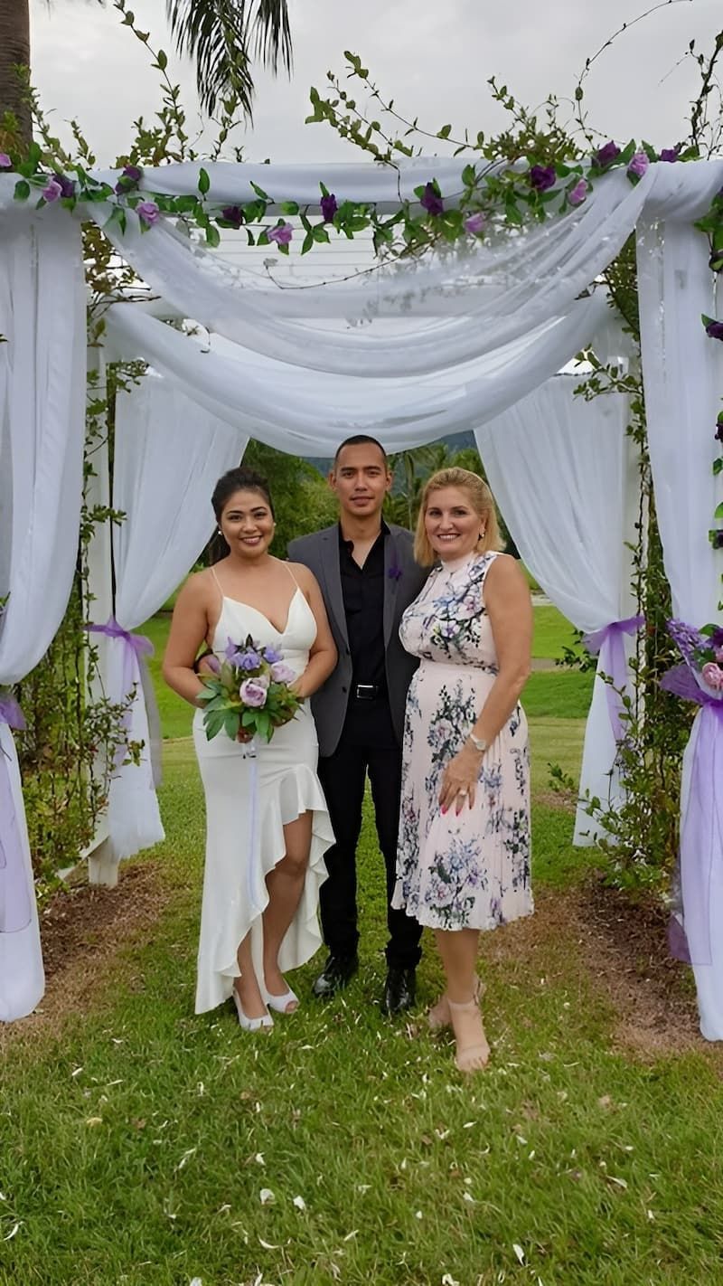 A Bride and Groom Are Posing for a Picture Under a White Canopy — GinaS Cairns Tropical Weddings in Parramatta Park, QLD