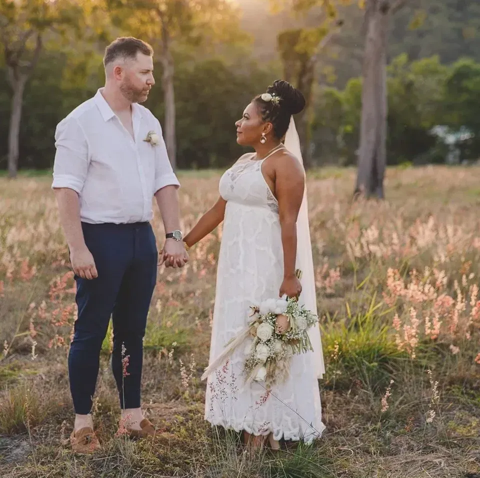 A Bride and Groom Are Holding Hands in a Field — GinaS Cairns Tropical Weddings in Parramatta Park, QLD