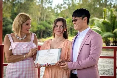 A Man and Two Women Next to Each Other Holding a Certificate — GinaS Cairns Tropical Weddings in Parramatta Park, QLD