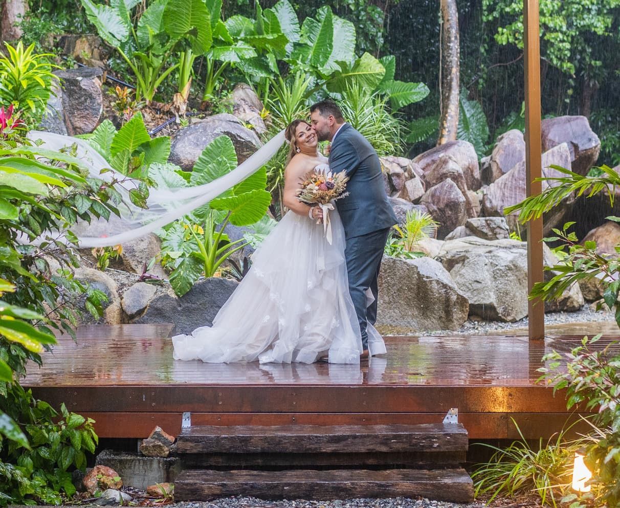 A Bride and Groom Are Sitting on a Set of Stairs — GinaS Cairns Tropical Weddings in Parramatta Park, QLD