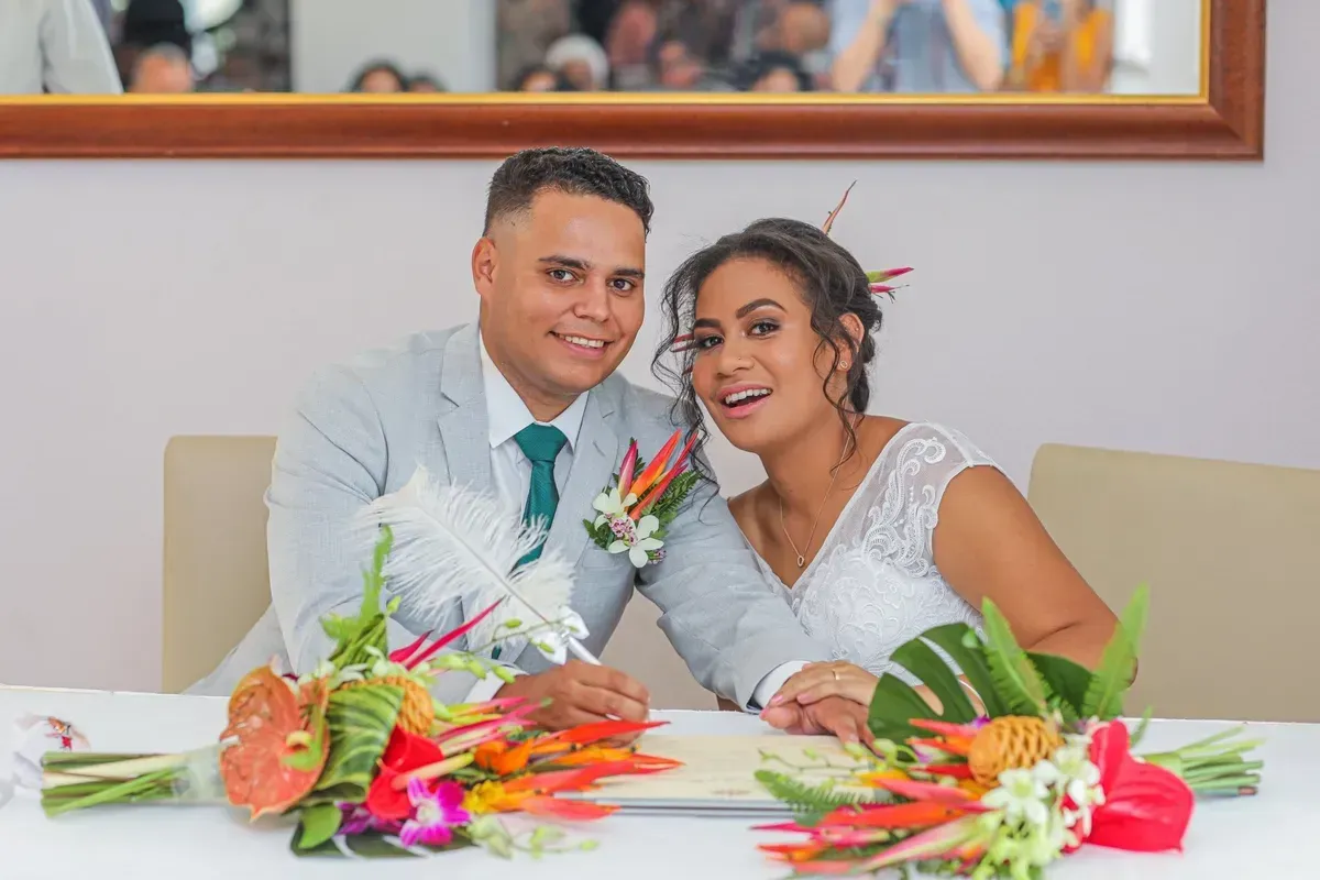 A Bride and Groom Are Sitting at a Table With Flowers — GinaS Cairns Tropical Weddings in Parramatta Park, QLD