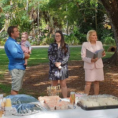 A Group of People Are Standing Around a Table in a Park — GinaS Cairns Tropical Weddings in Parramatta Park, QLD