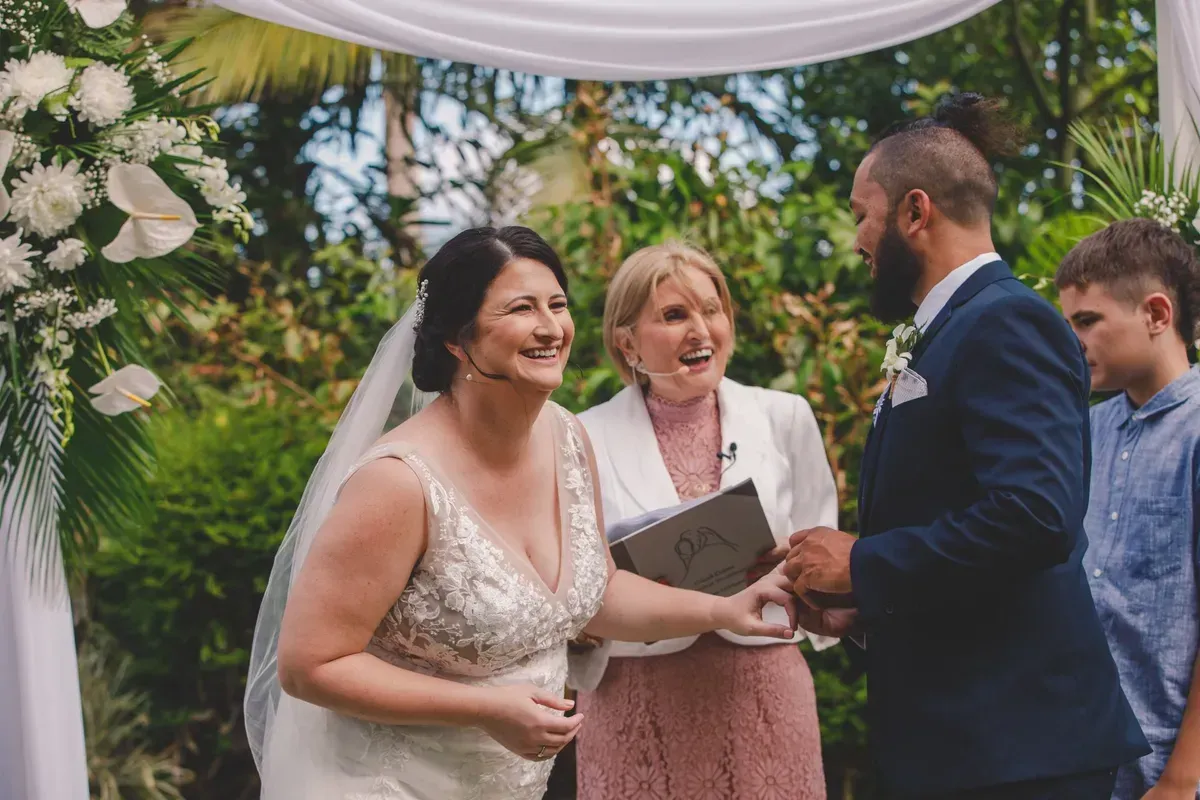 A Bride and Groom Are Holding Hands During Their Wedding Ceremony — GinaS Cairns Tropical Weddings in Parramatta Park, QLD