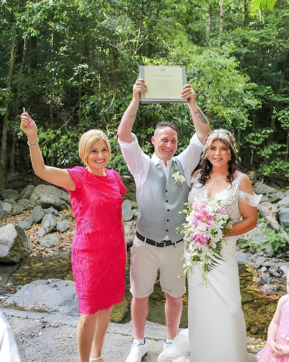 A Bride and Groom Are Next to Each Other Holding a Certificate — GinaS Cairns Tropical Weddings in Parramatta Park, QLD