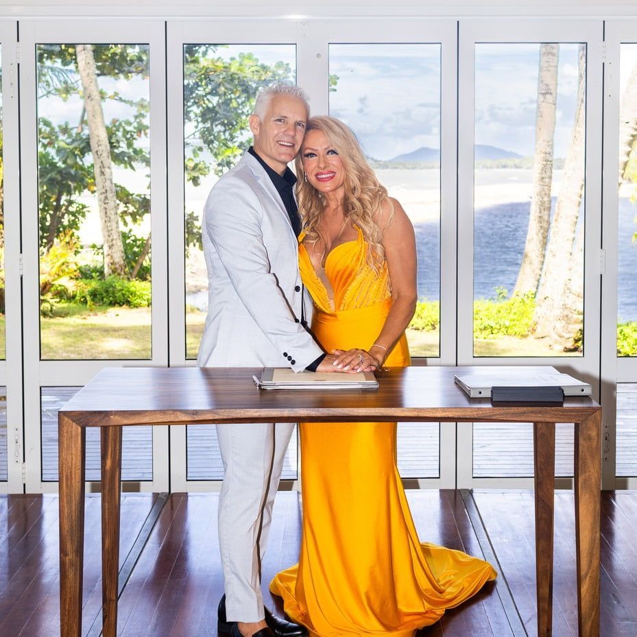 A Bride and Groom Are Holding a Bouquet of Flowers — GinaS Cairns Tropical Weddings in Parramatta Park, QLD