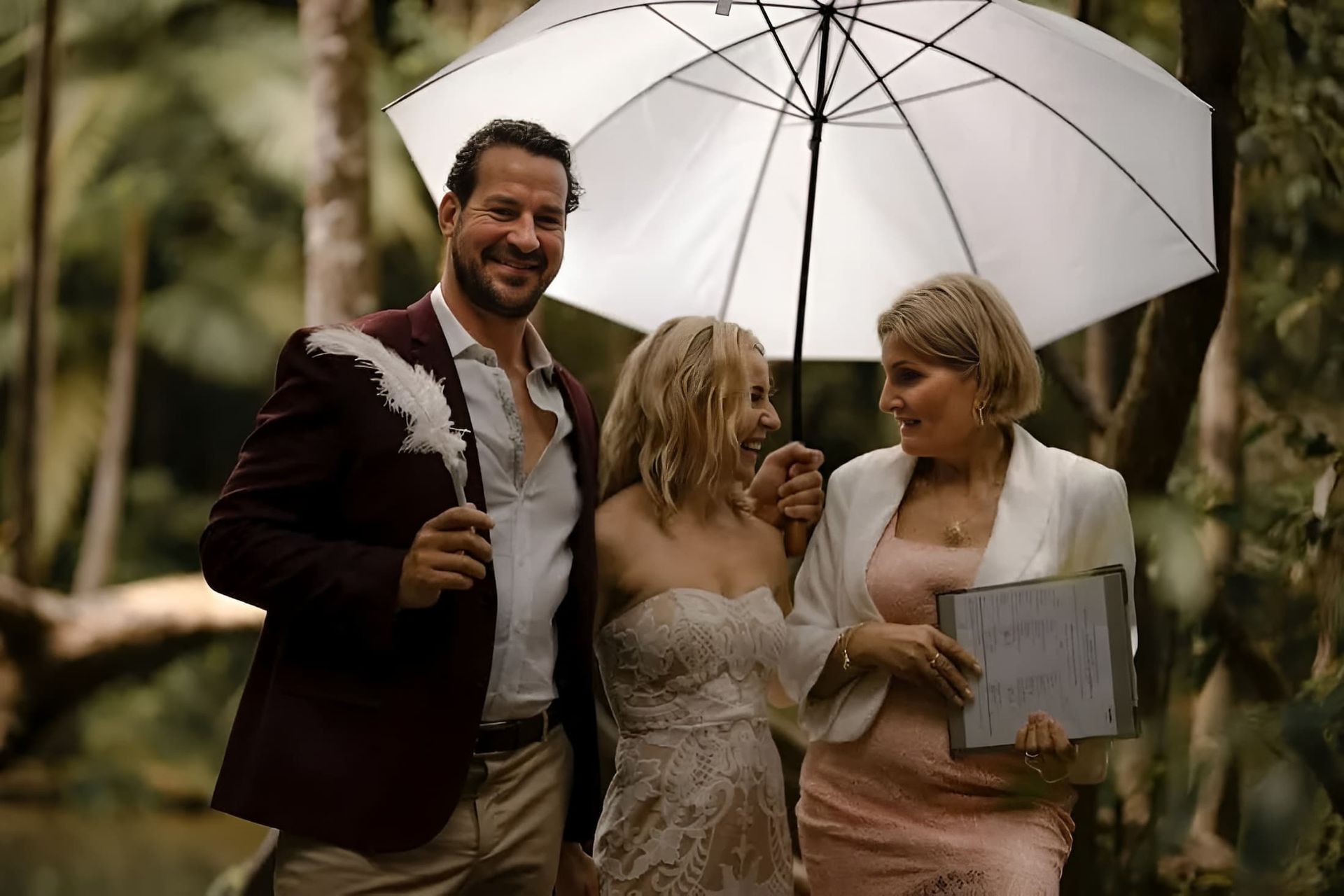 A Bride and Groom With a Woman Holding an Umbrella — GinaS Cairns Tropical Weddings in Parramatta Park, QLD