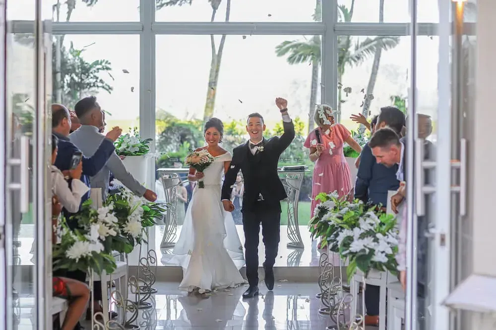 A Bride and Groom Are Walking Down the Aisle at Their Wedding — GinaS Cairns Tropical Weddings in Parramatta Park, QLD