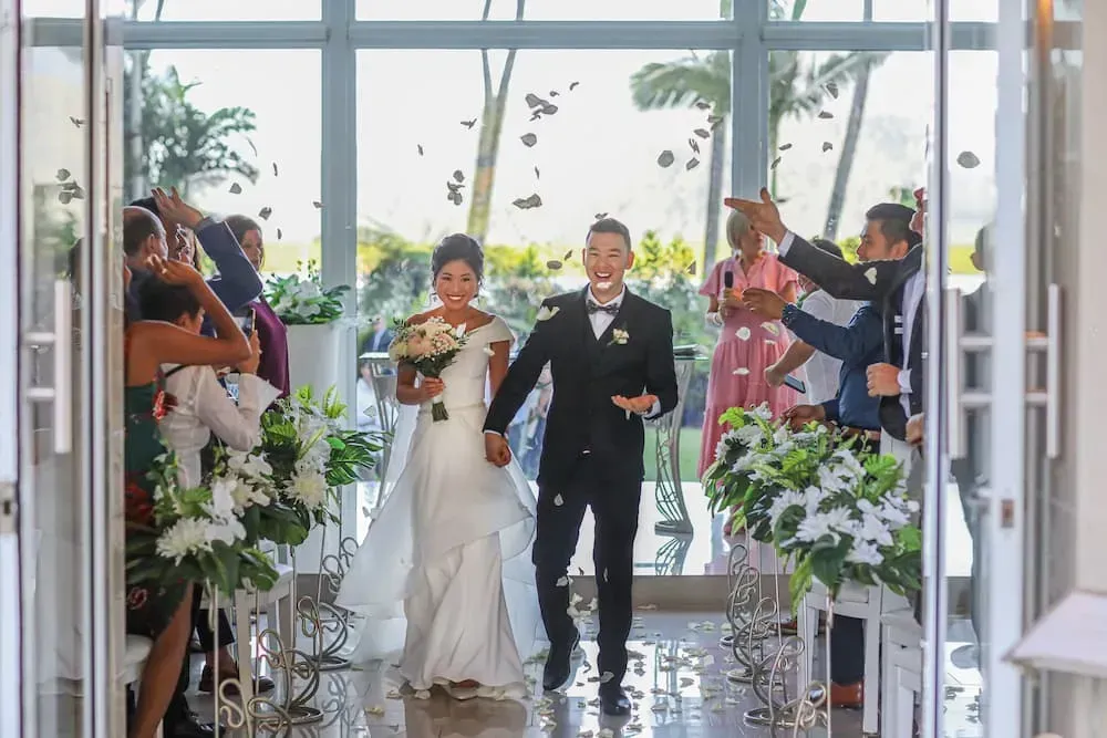A Bride and Groom Are Walking Down the Aisle at Their Wedding — GinaS Cairns Tropical Weddings in Parramatta Park, QLD