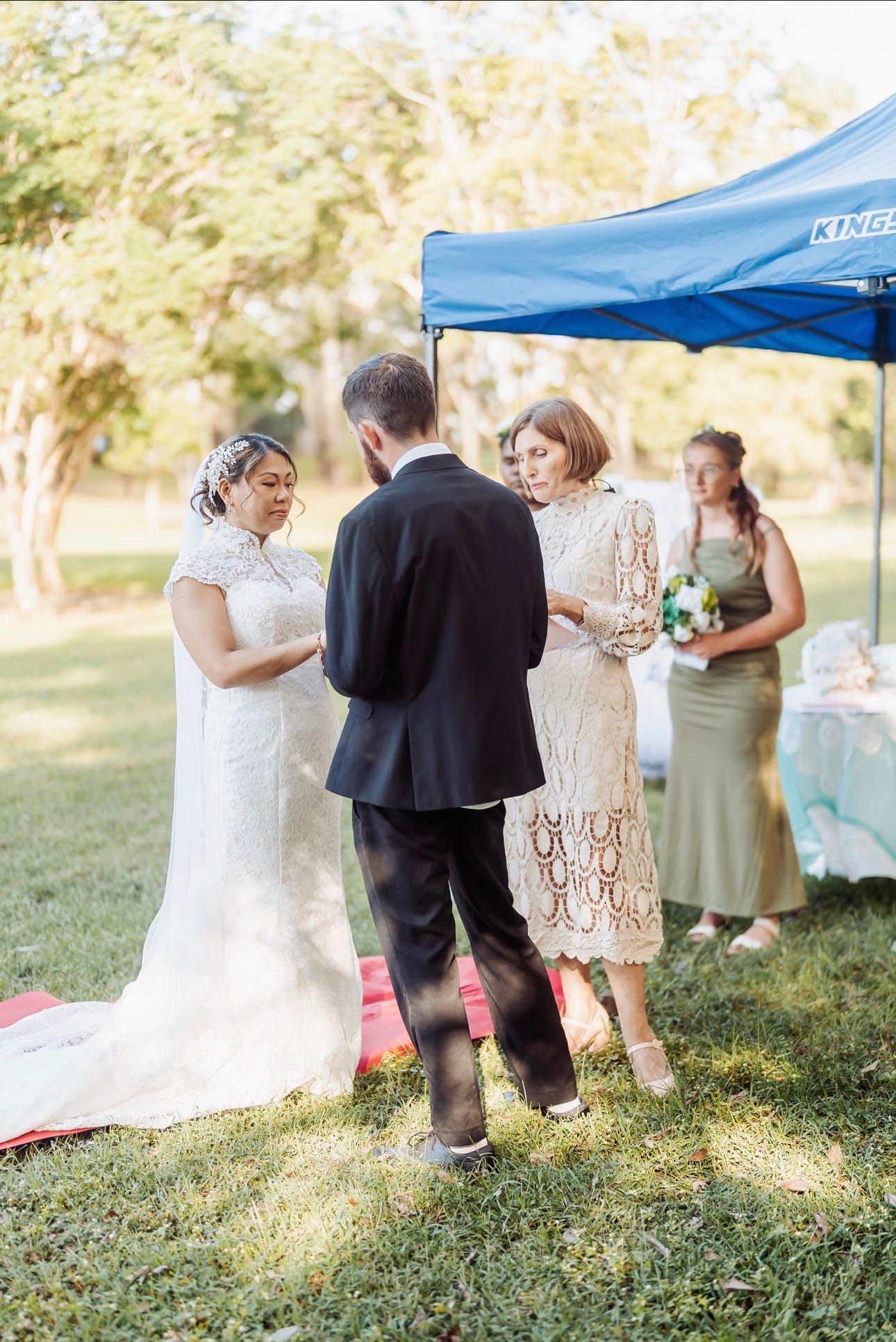 Bride and groom with officiant at an outdoor wedding — GinaS Cairns Tropical Weddings in Parramatta Park, QLD