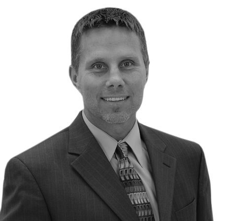 A man in a suit and tie is smiling for the camera