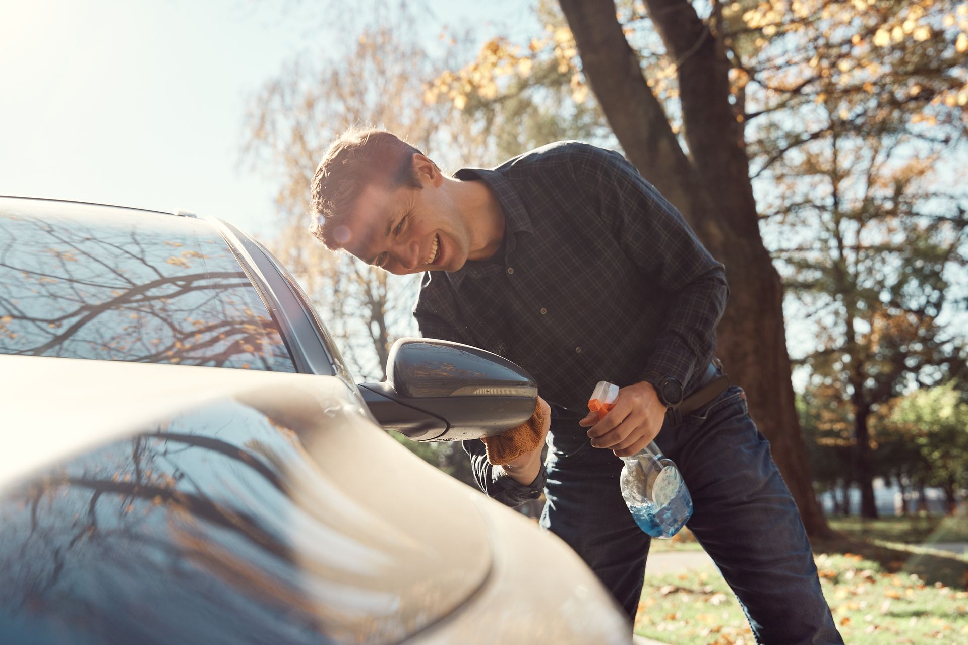 A towel and a sponge are sitting on top of a car.